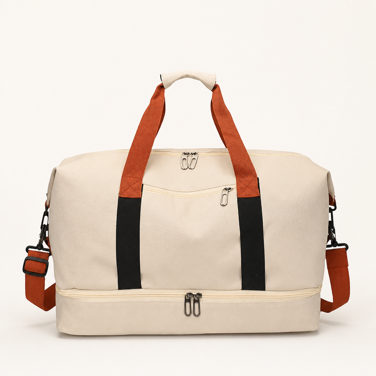 Cream travel gym duffel with orange-brown handles and shoulder strap, black webbing, front zip pocket and lower zip compartment.